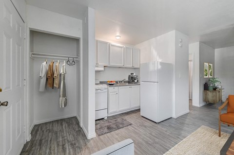 A white kitchen with a washing machine in the corner.