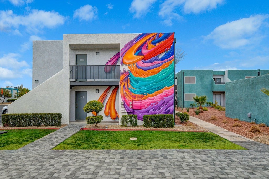 A colorful mural on a building in a residential area.