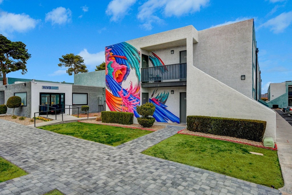 A modern building with a colorful mural on the side.