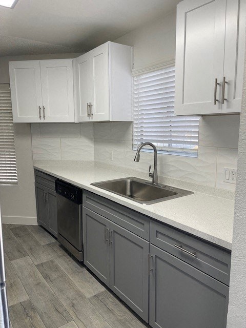 A kitchen with a sink and cabinets.