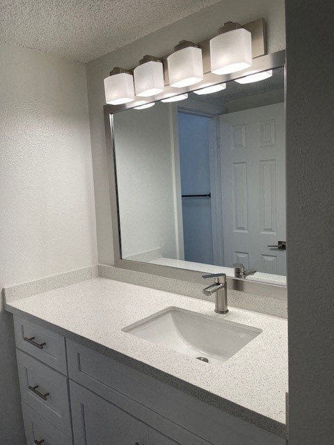 A bathroom with a sink and mirror.