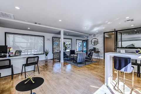 A modern living room with a black coffee table and a white dining table.