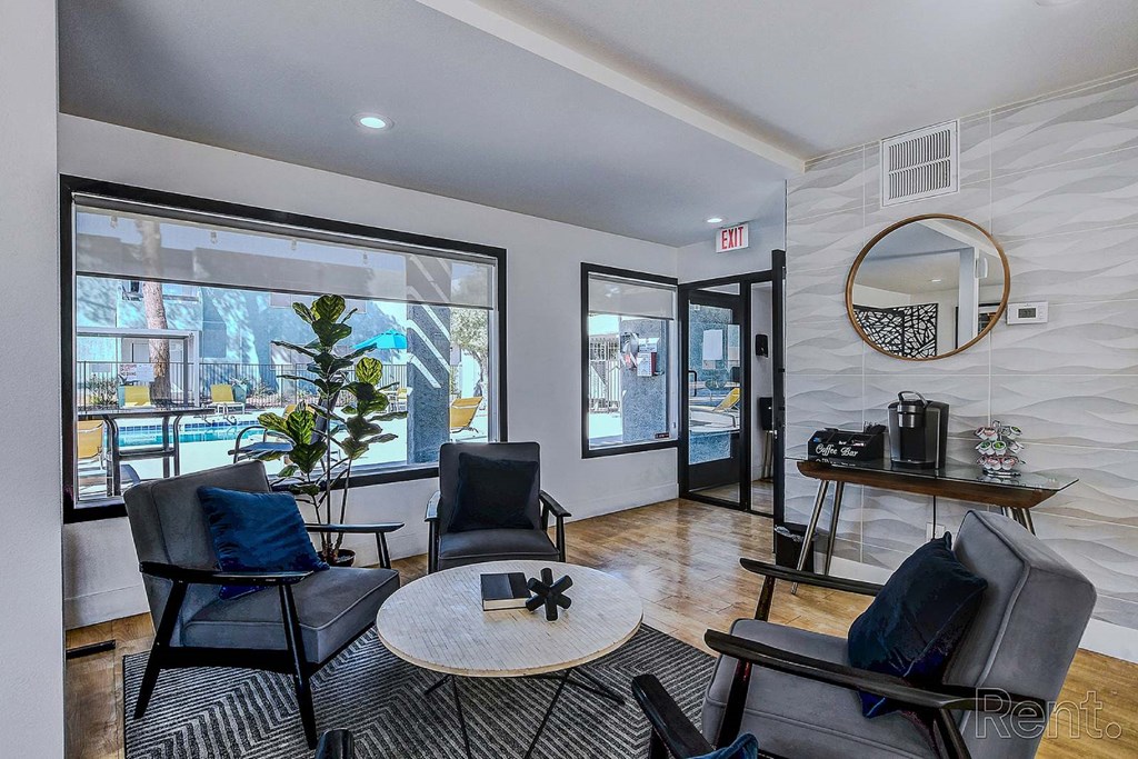 A living room with a black chair and a round table.