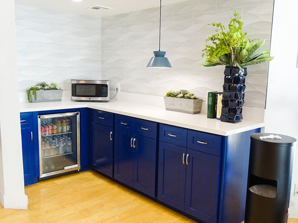 A kitchen with blue cabinets and a white countertop.
