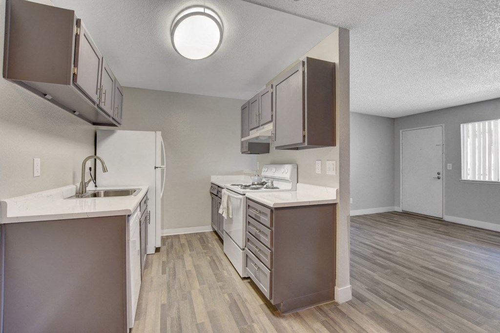 A kitchen with white appliances and a white counter top.