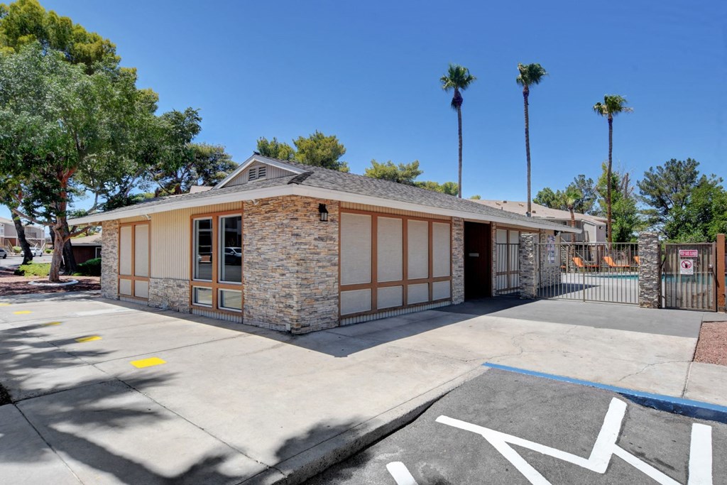 A building with a parking lot in front of it.