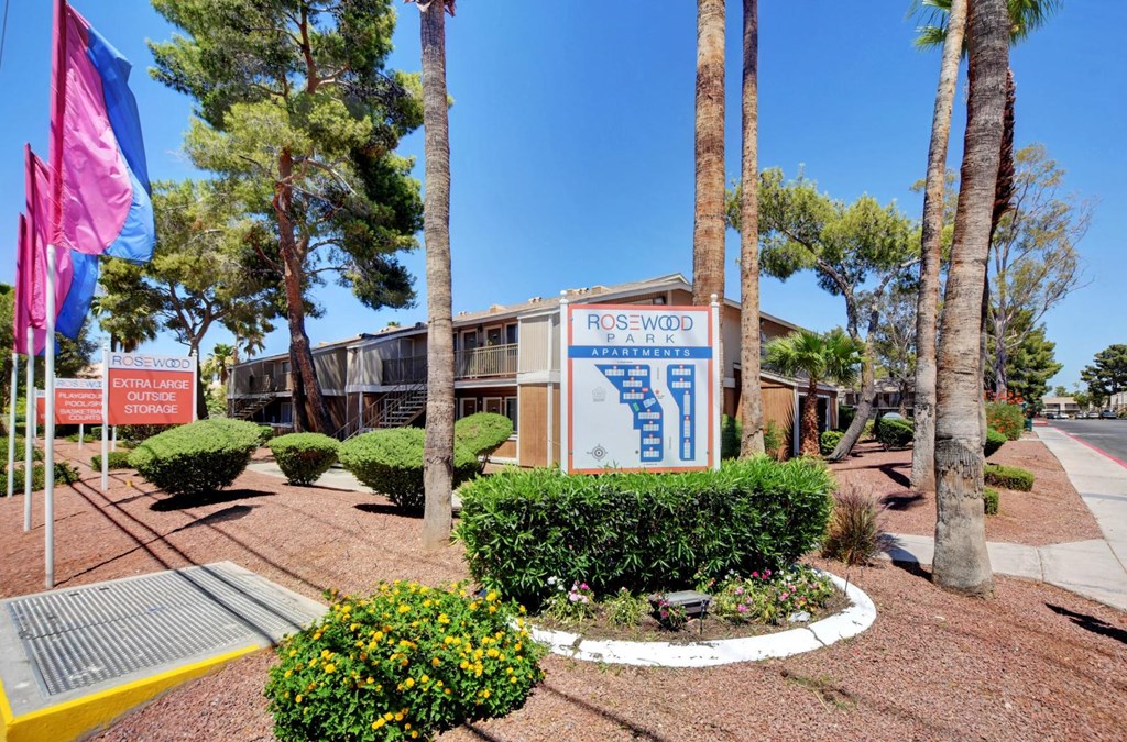 A sign for Rosewood Park is displayed in front of a building.