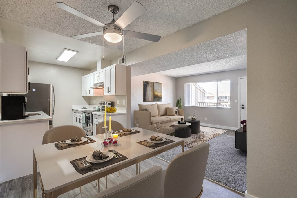 A modern kitchen with a dining table set for two.