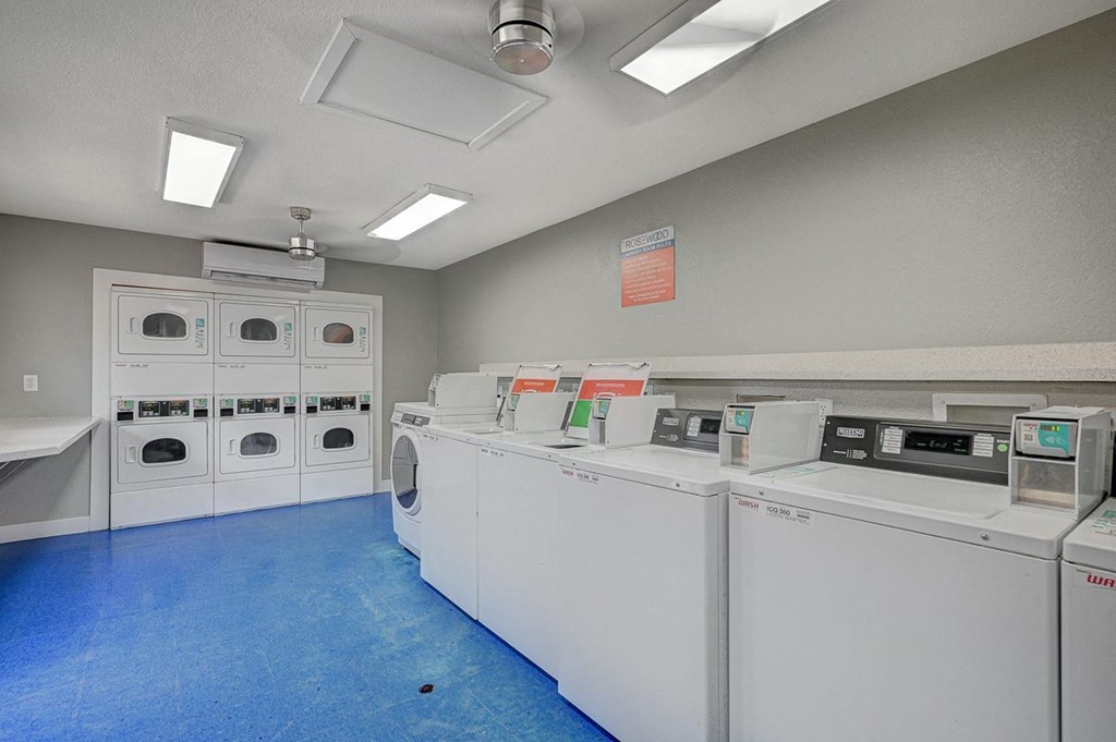 A laundry room with washers and dryers.