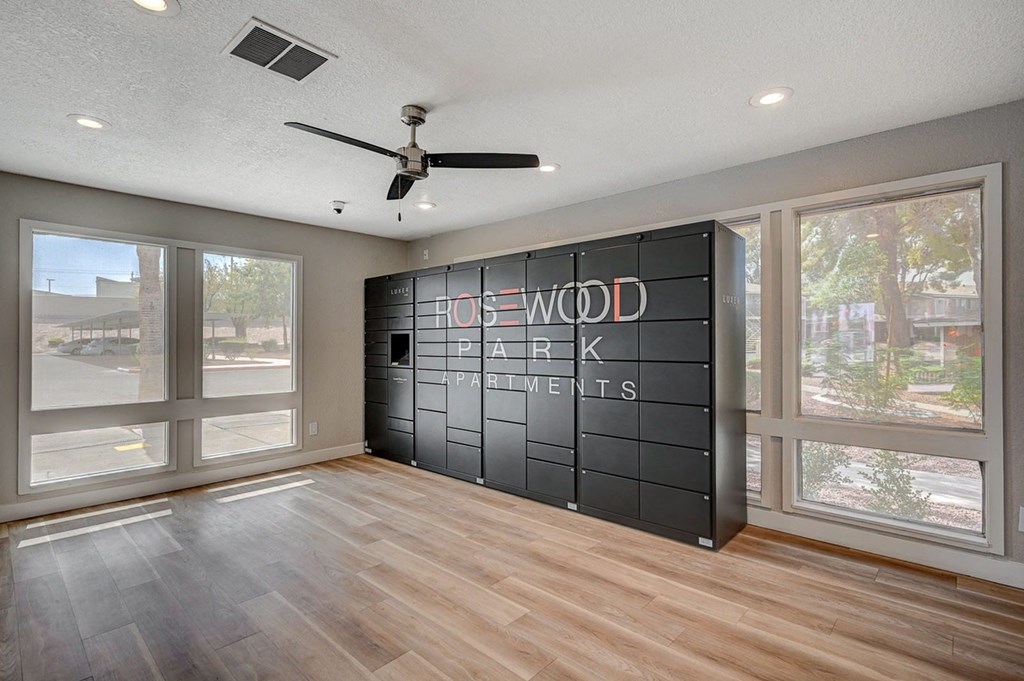 A room with a wooden floor and a sign that says "House Park Apartments".