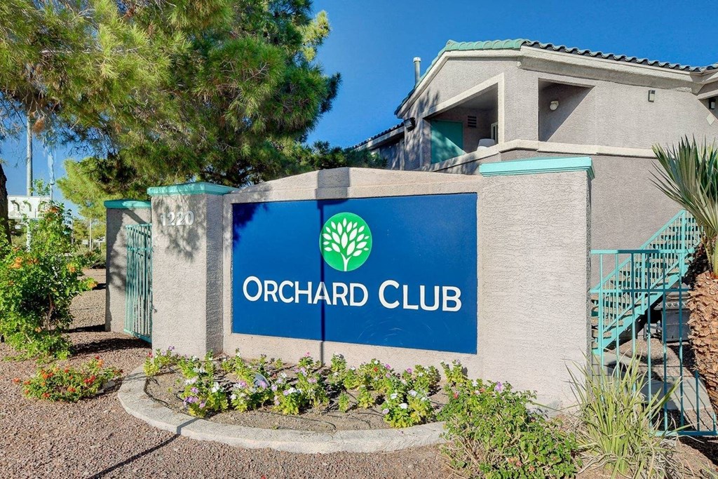A sign for the Orchard Club is displayed in front of a building.