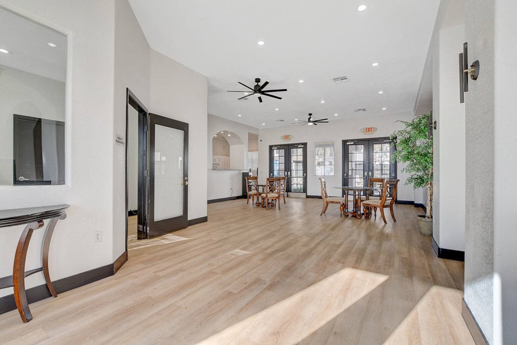 A room with wooden floors and a ceiling fan.