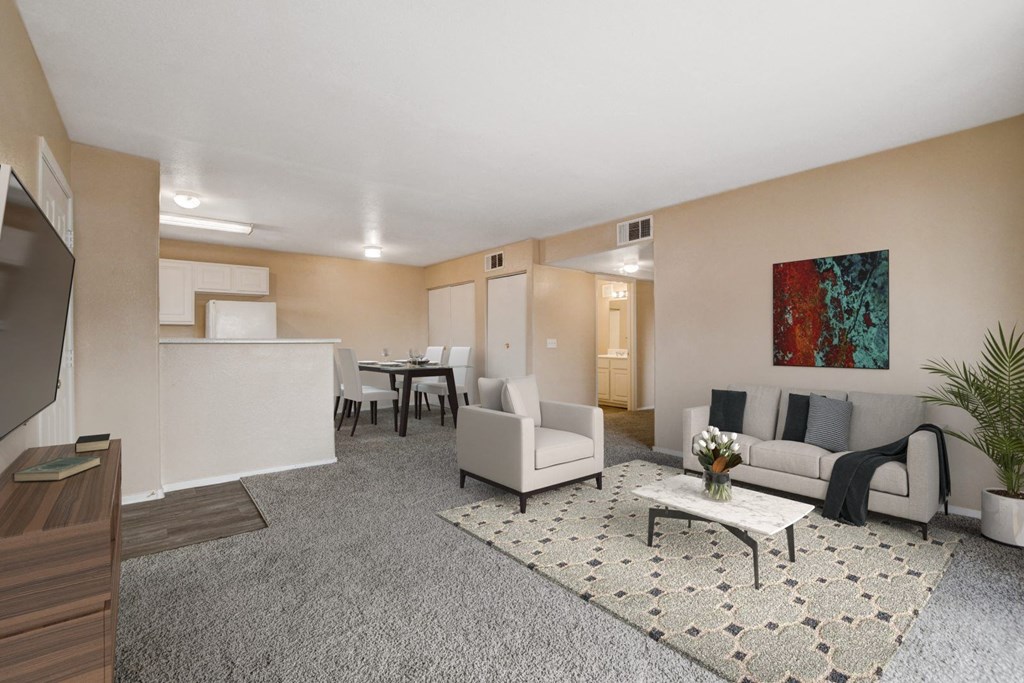 A living room with a grey carpet and a white sofa.