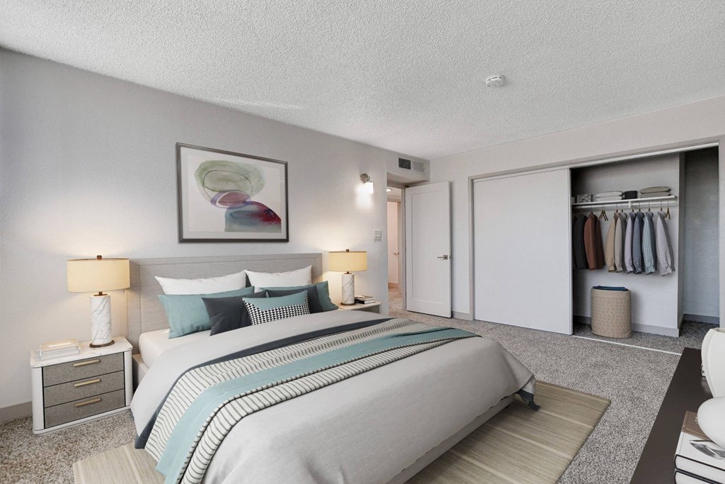 A bedroom with a large bed and a painting on the wall.