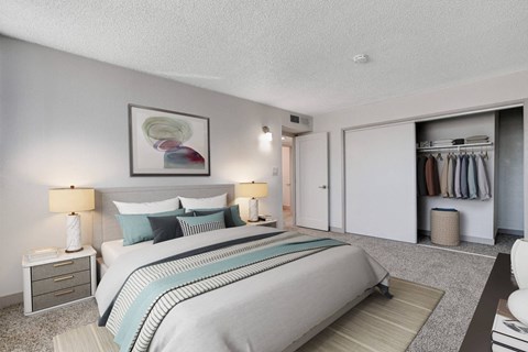 A bedroom with a large bed and a painting on the wall.