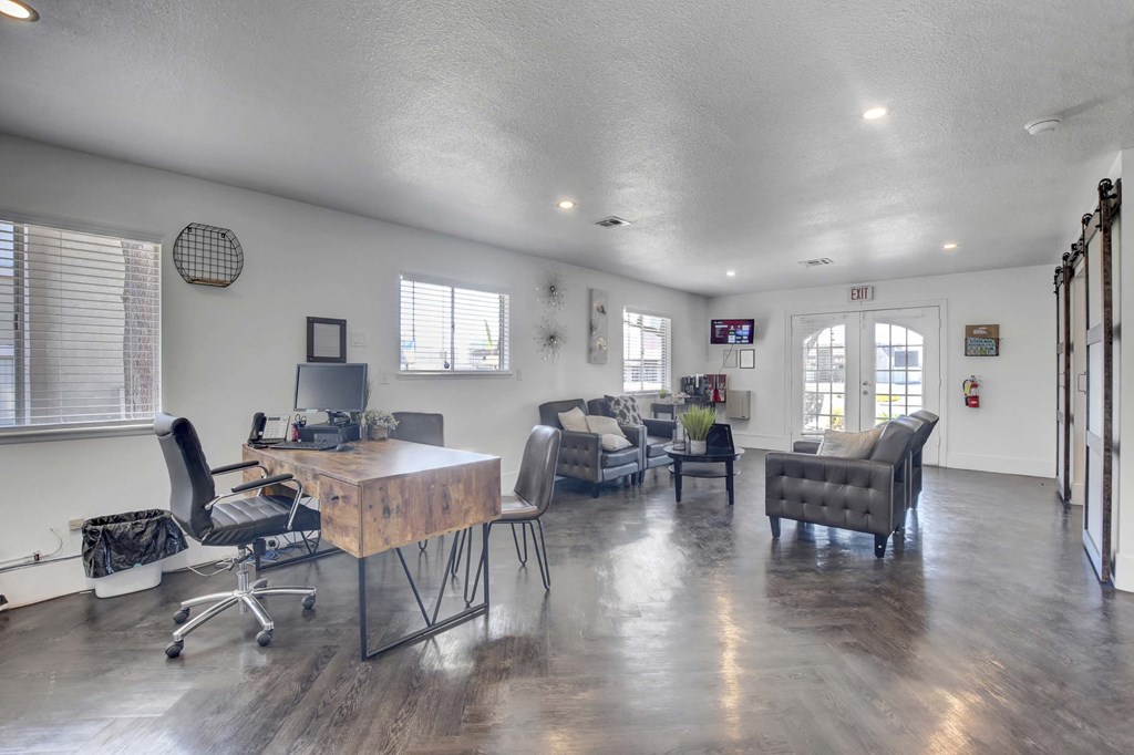 A spacious room with a wooden table and chairs.