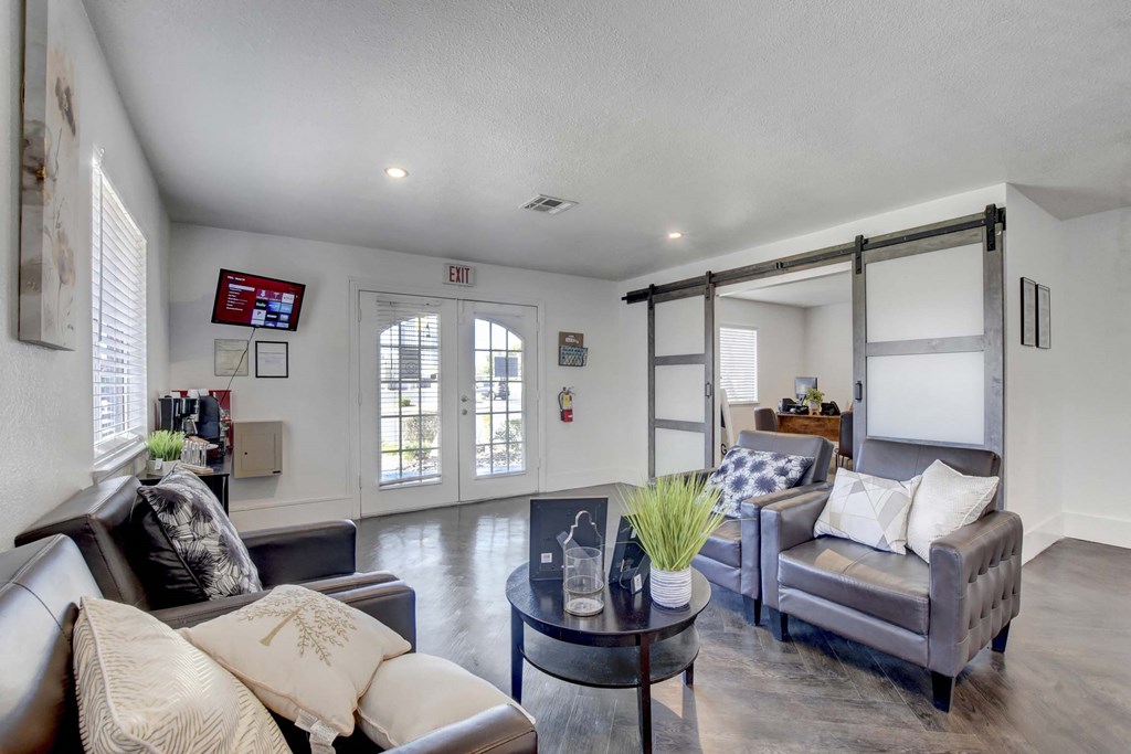 A living room with a grey couch and a coffee table.