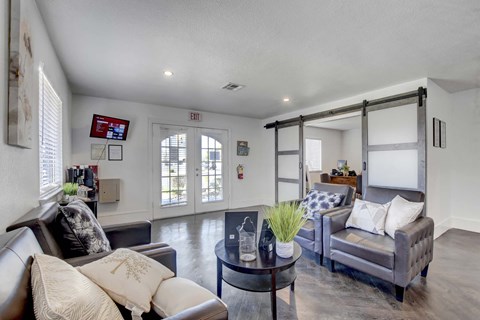 A modern living room with a grey couch and a coffee table.
