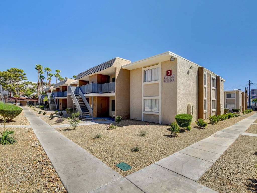 A row of houses with a clear blue sky above them.