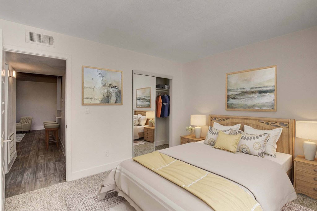 A bedroom with a large bed and a painting on the wall.