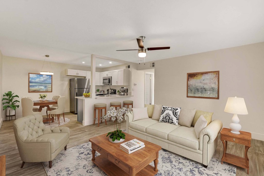 A living room with a beige sofa, a wooden coffee table, and a painting on the wall.