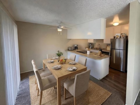 A kitchen with a dining table set for four.