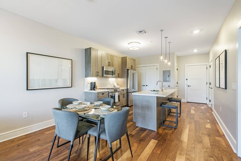 A modern kitchen with a dining table set for four.