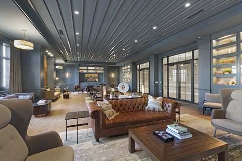 A living room with a brown leather couch and a wooden coffee table.