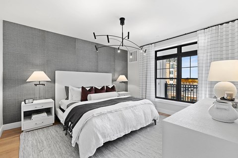 A modern bedroom with a large bed and a balcony.