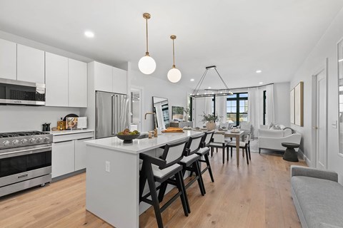 A modern kitchen with a dining table and chairs.