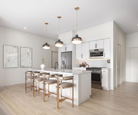 A modern kitchen with a white island and bar stools.