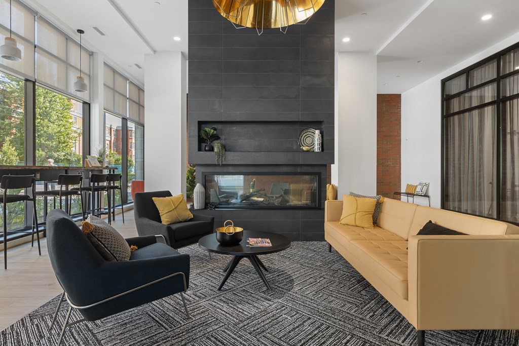 A modern living room with a fireplace and a large window.