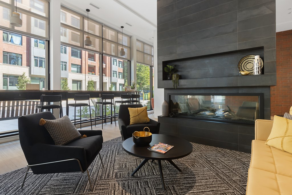 A living room with a fireplace and a coffee table.