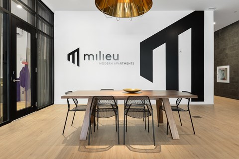 A modern dining room with a wooden table and chairs.