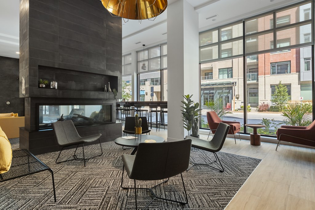 A modern living room with a fireplace and comfortable seating.