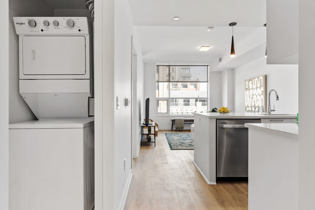 A modern kitchen with a stainless steel dishwasher and a white oven.