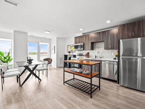 A modern kitchen with a dining table and chairs.