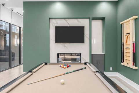 A pool table with a white ball and two cues in the middle of it.