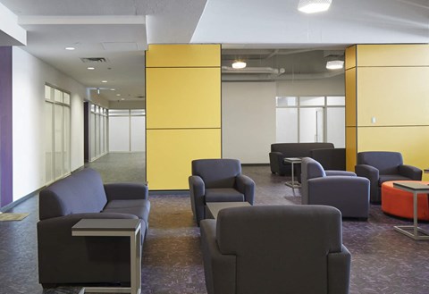 A room with purple carpet and yellow walls.
