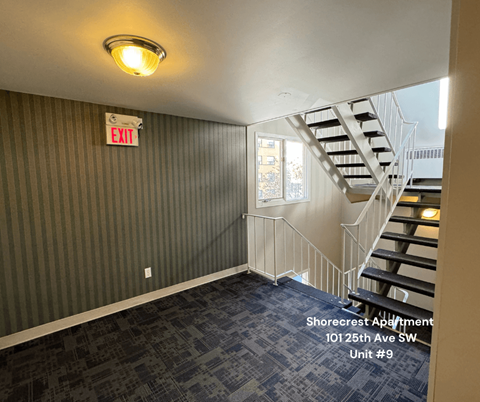 A room with a striped wall and a staircase.