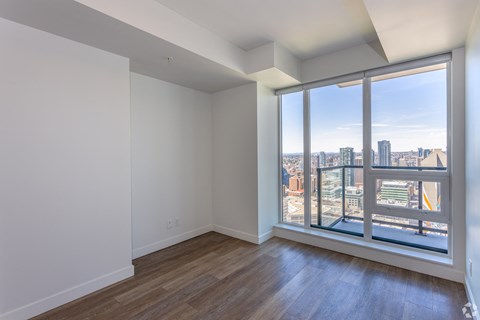 Empty room with a view of the cityscape outside.