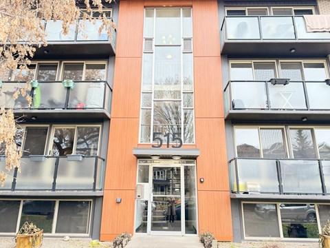A modern building with a glass entrance and balconies.