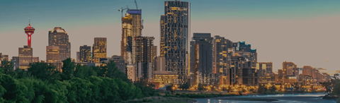 A city skyline with a tall tower and a red tower in the background.