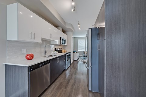 A modern kitchen with a refrigerator on the right.