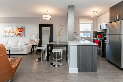 A modern kitchen with a white island and stainless steel appliances.