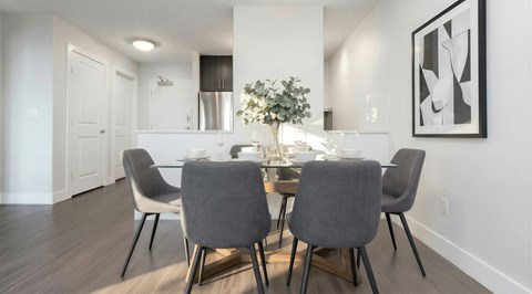 A modern dining room with a table set for four.