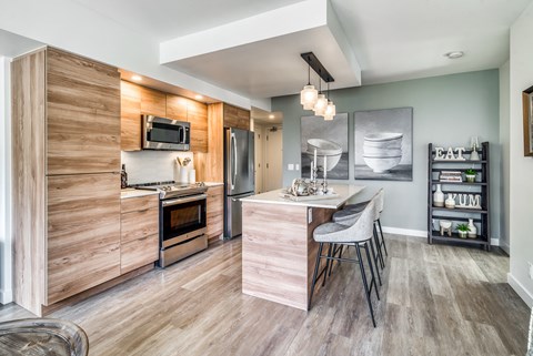 A modern kitchen with a wooden cabinet and a white countertop.