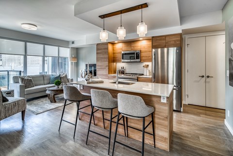 A modern kitchen with a bar stool and a countertop.