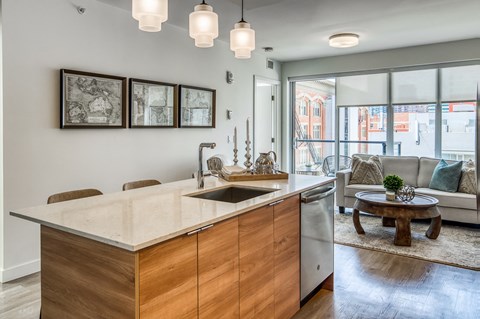 A modern kitchen with wooden cabinets and a large island.