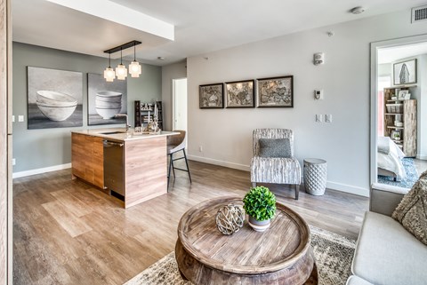 A living room with a wooden coffee table and a grey armchair.